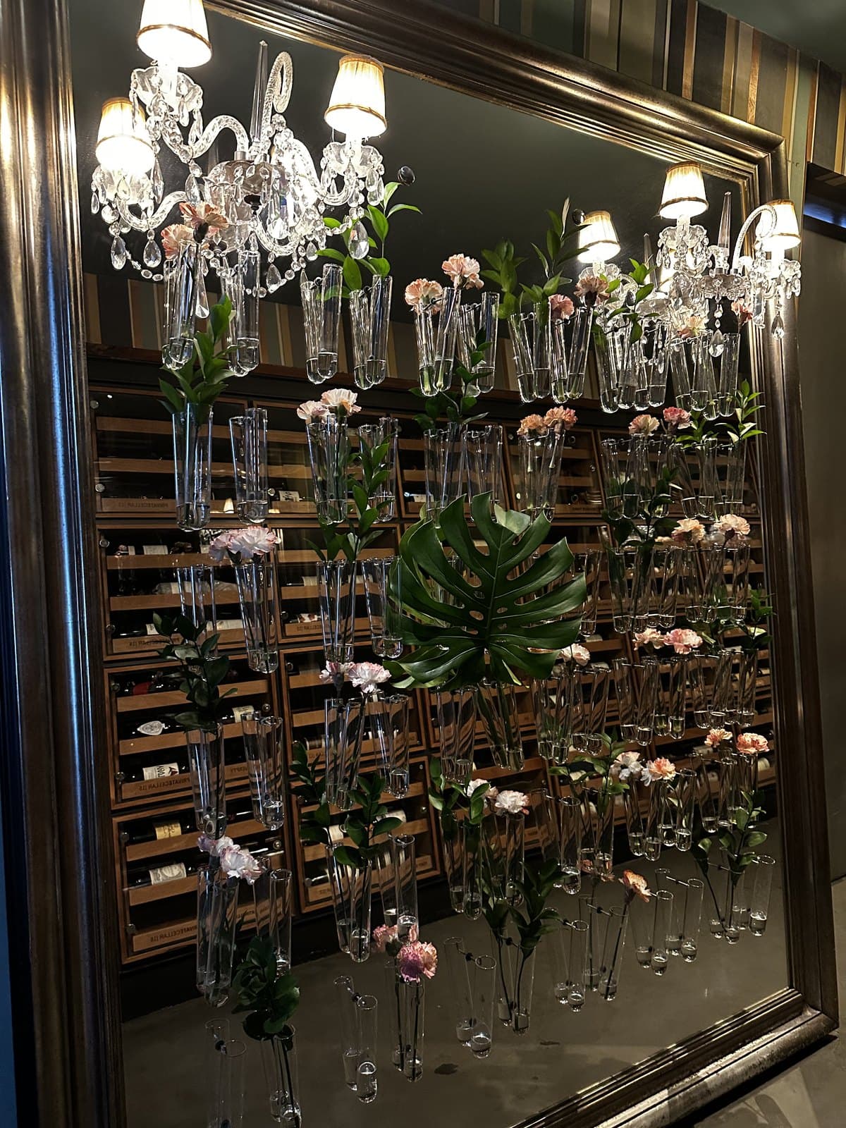 The flower wall and chandelier at the entrance to Azahar, the florist front that hides the dining room