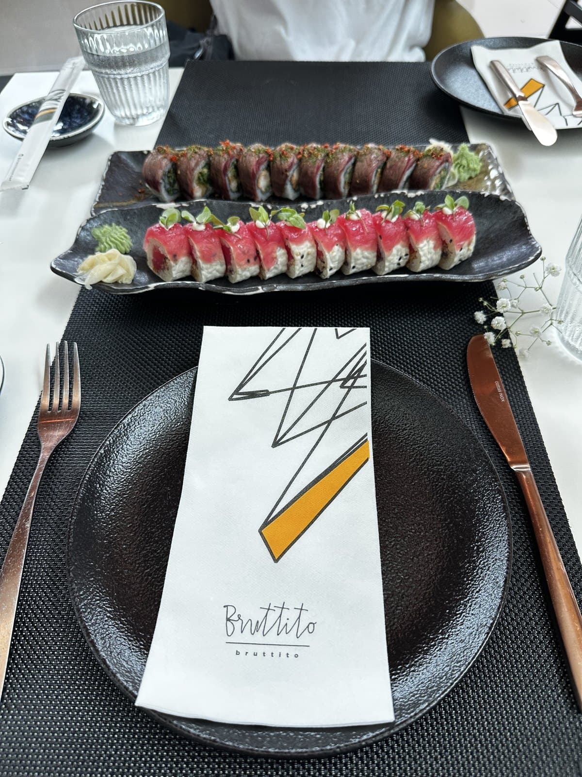 Two rolls side by side at Bruttito, the beef-wrapped Angus and the tuna-topped ATP 13