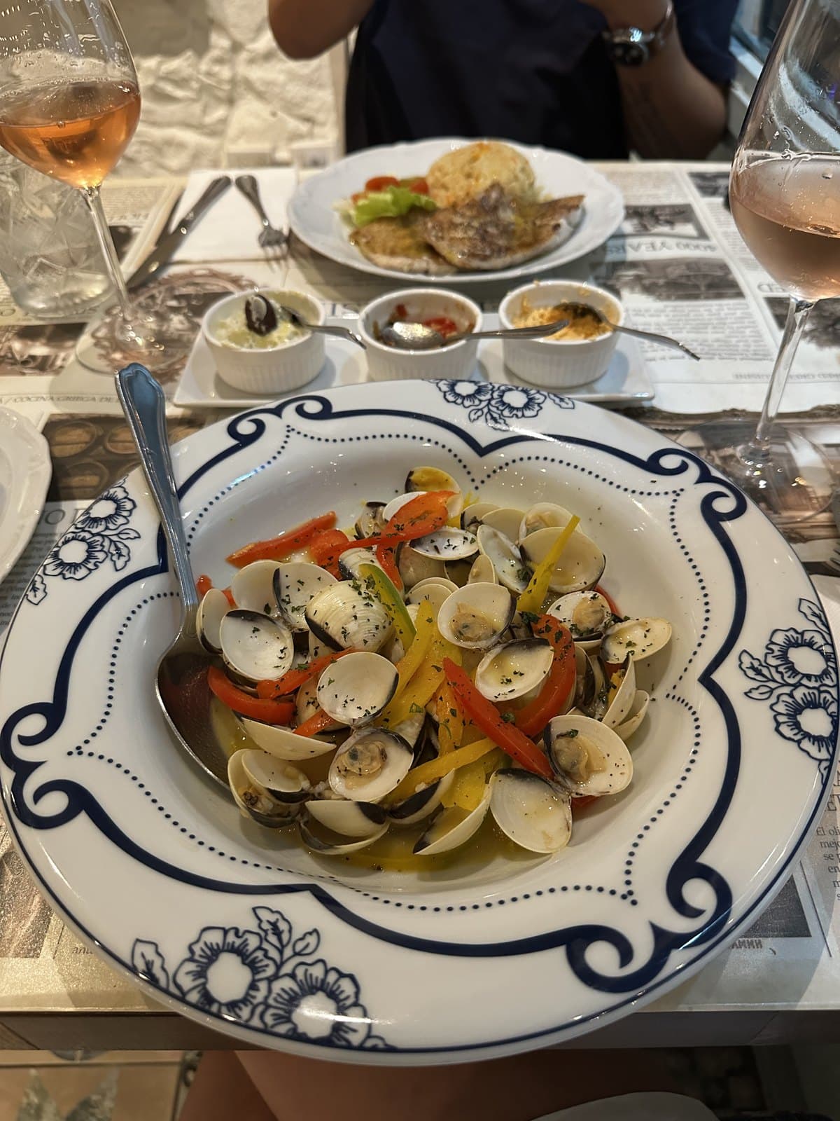 Garlic clams at Meze with peppers, served in a blue-rimmed bowl