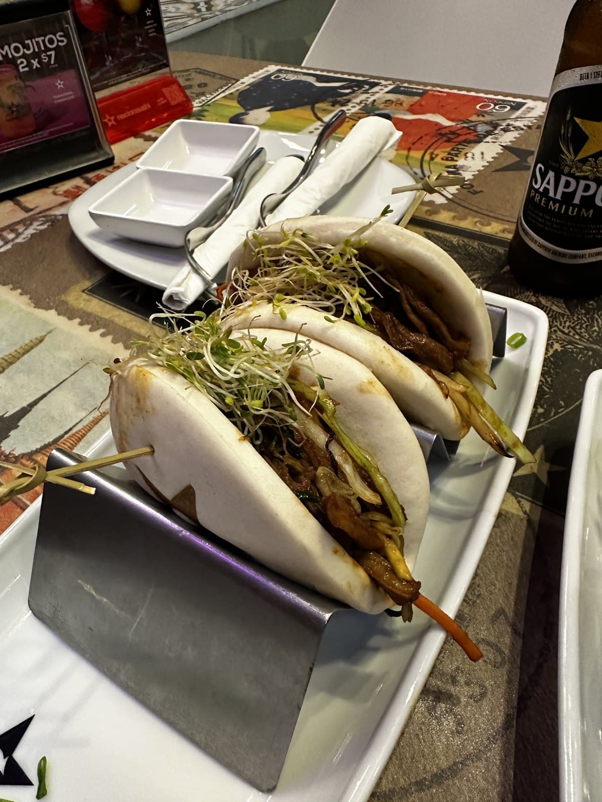 Pork baos at Nacion Sushi, filled steamed buns topped with sprouts