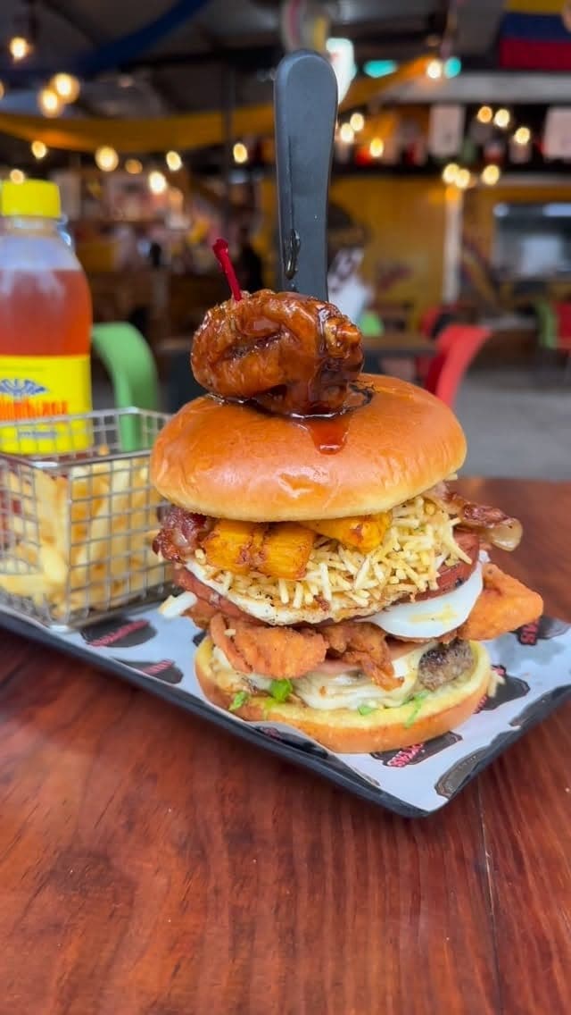 Loaded stacked burger with fries at Arepitas Pa Q Joder, San Francisco, Panama City