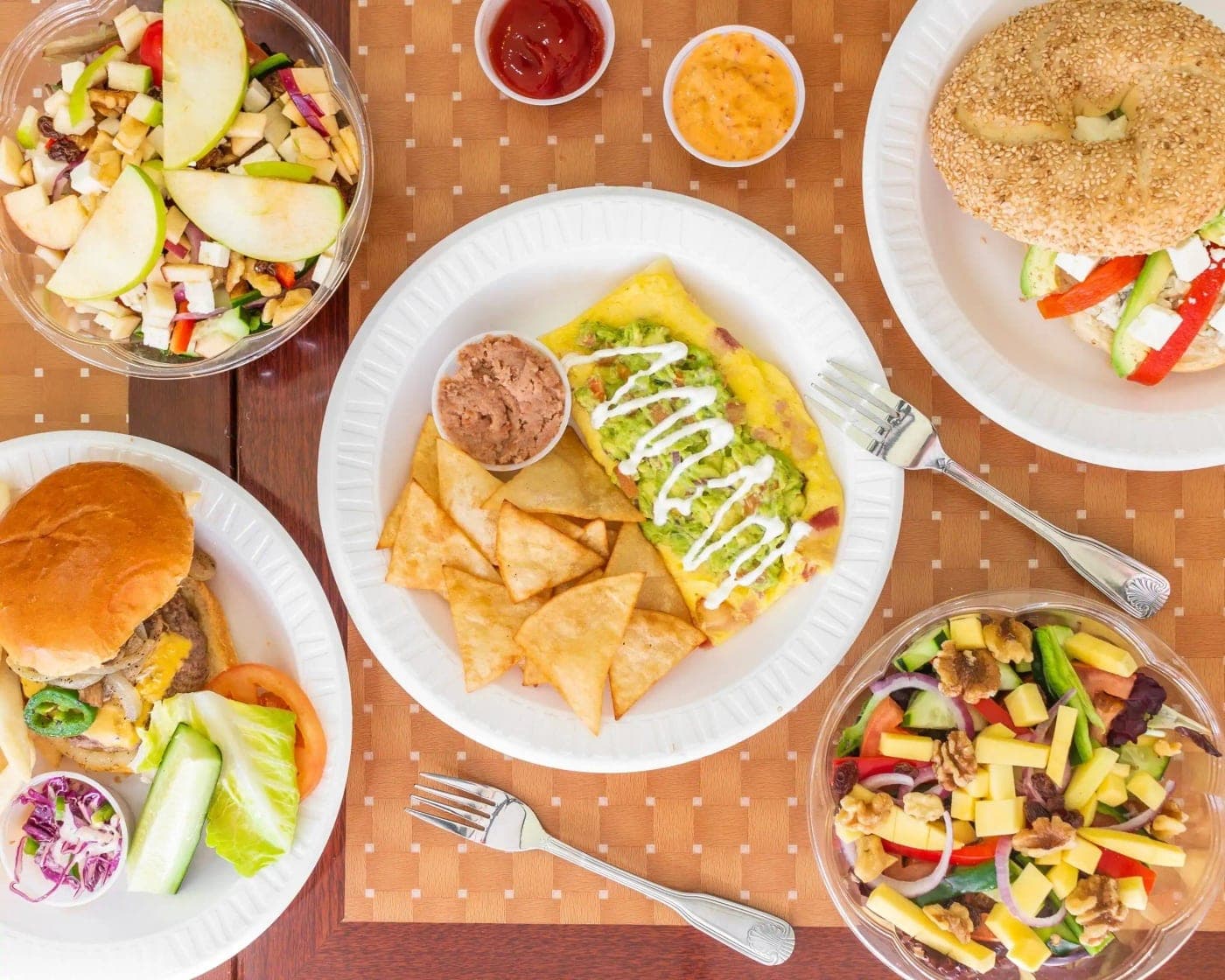 spread of burgers, nachos and salads at BreakBox Panama, Panama City