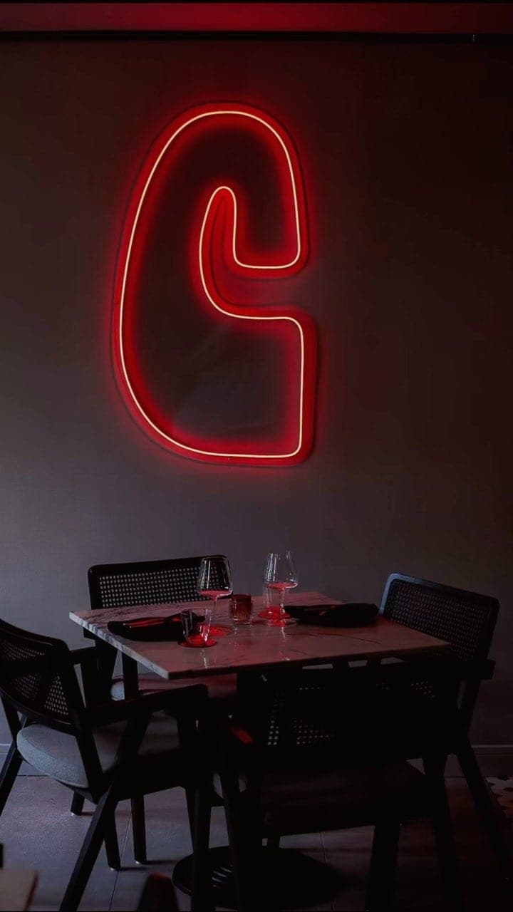 Dining room with neon sign at Celia Bar de Vinos y Restaurante, Panama City