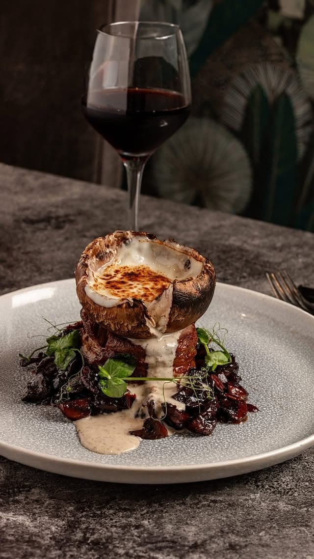 Beef topped with a gratinated stuffed portobello and a glass of red wine at Centrico Atypical Steakhouse, Bella Vista, Panama City