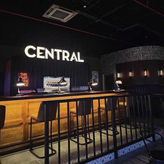 Taproom bar counter under the neon sign at Cerveceria Central, Panama City