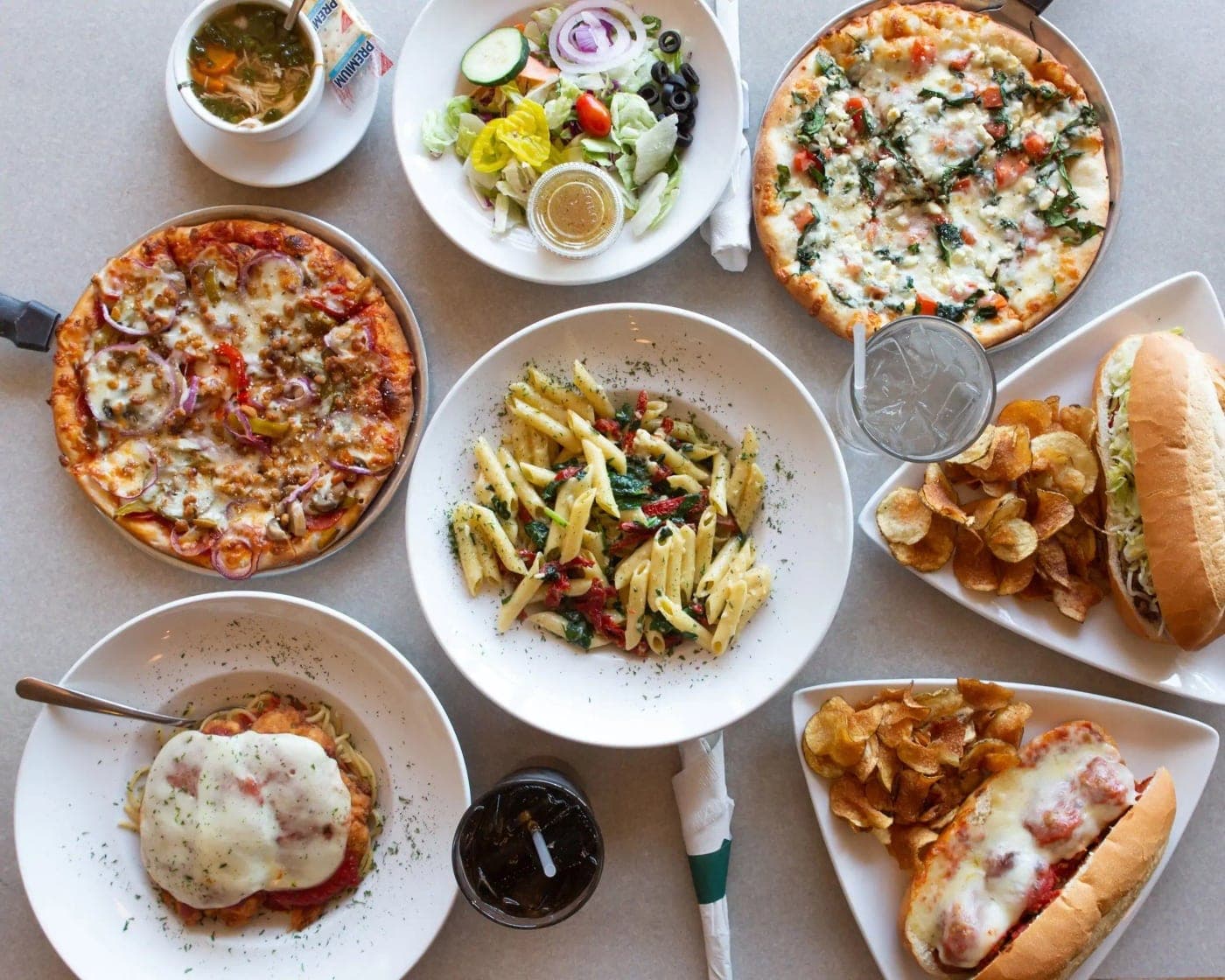 table spread of pizzas, pasta and sandwiches at Chillin plaza, Panama City