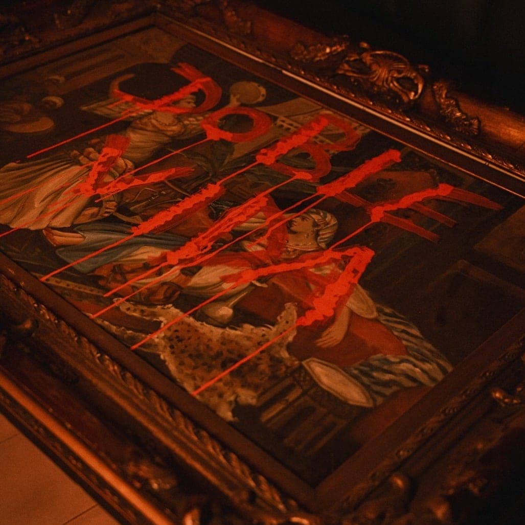 Gold-framed classical painting with red graffiti in the dim speakeasy interior at Corrupto, Casco Viejo, Panama City