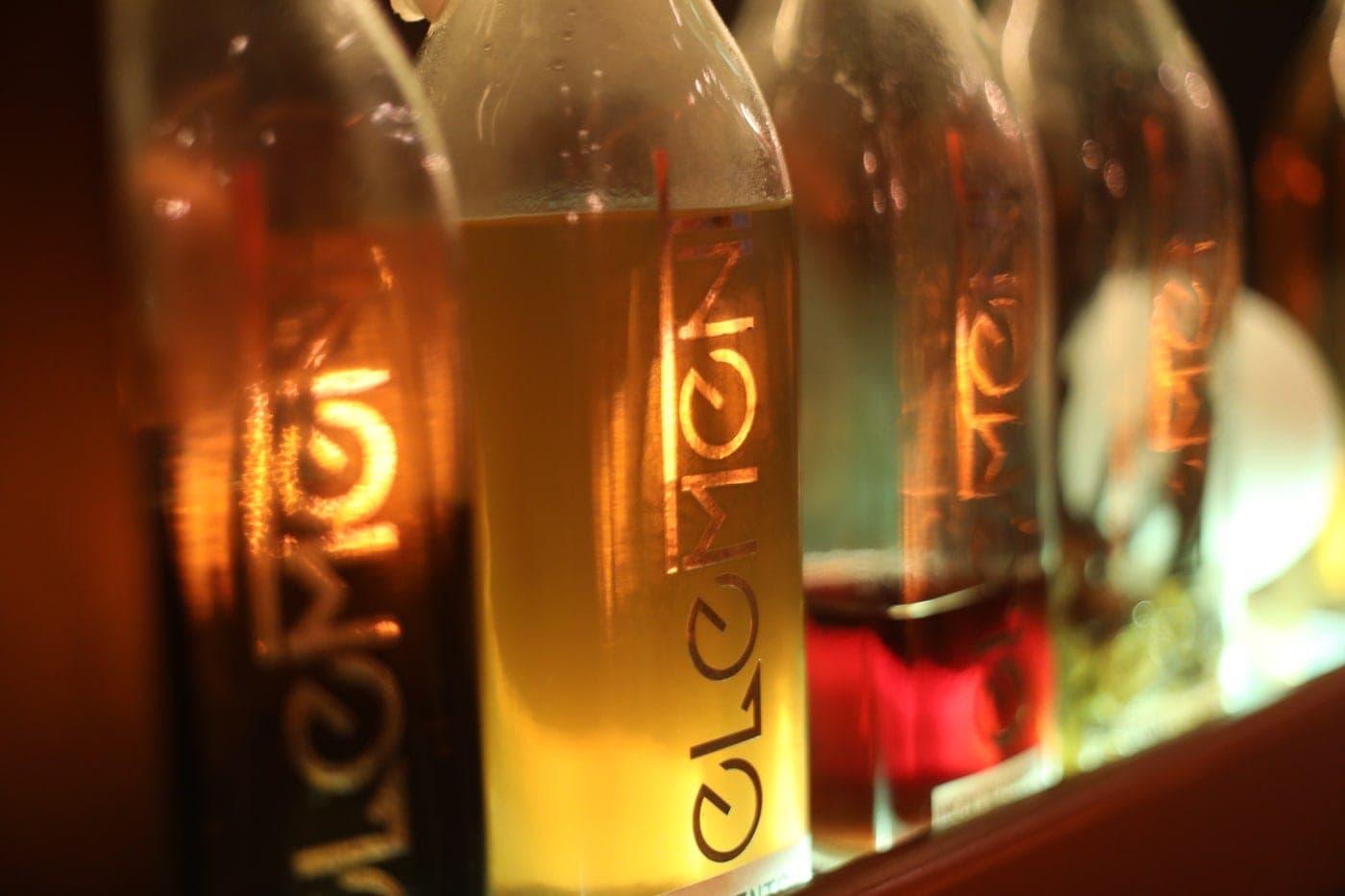 Backlit branded carafes of signature drinks on the bar at Element, Casco Viejo, Panama City