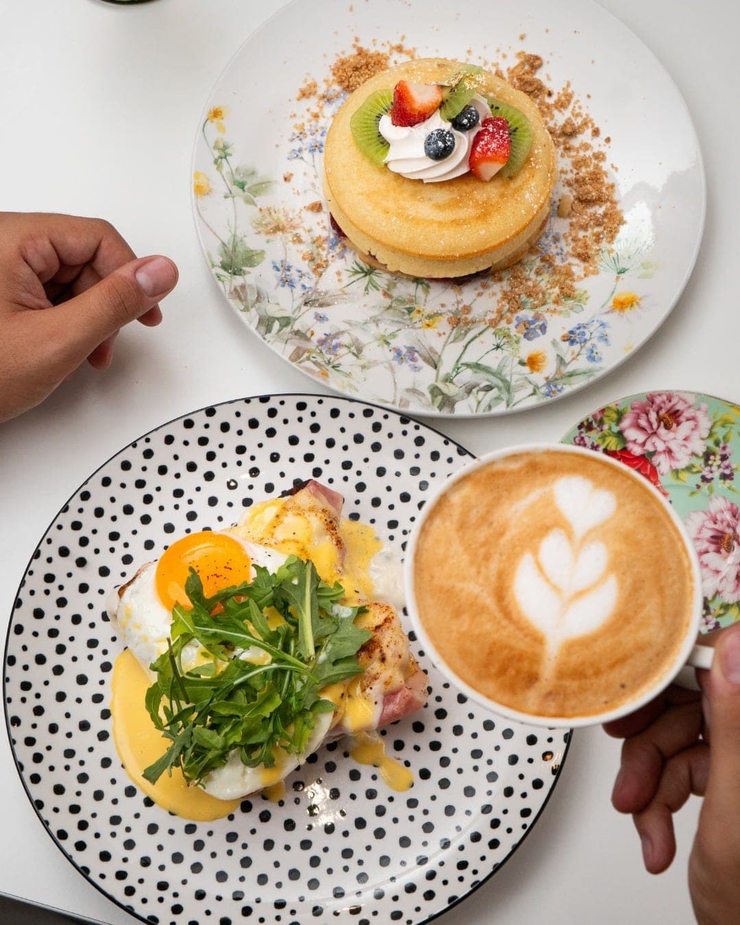 Brunch spread with eggs Benedict and a latte at Flavors, San Francisco, Panama City