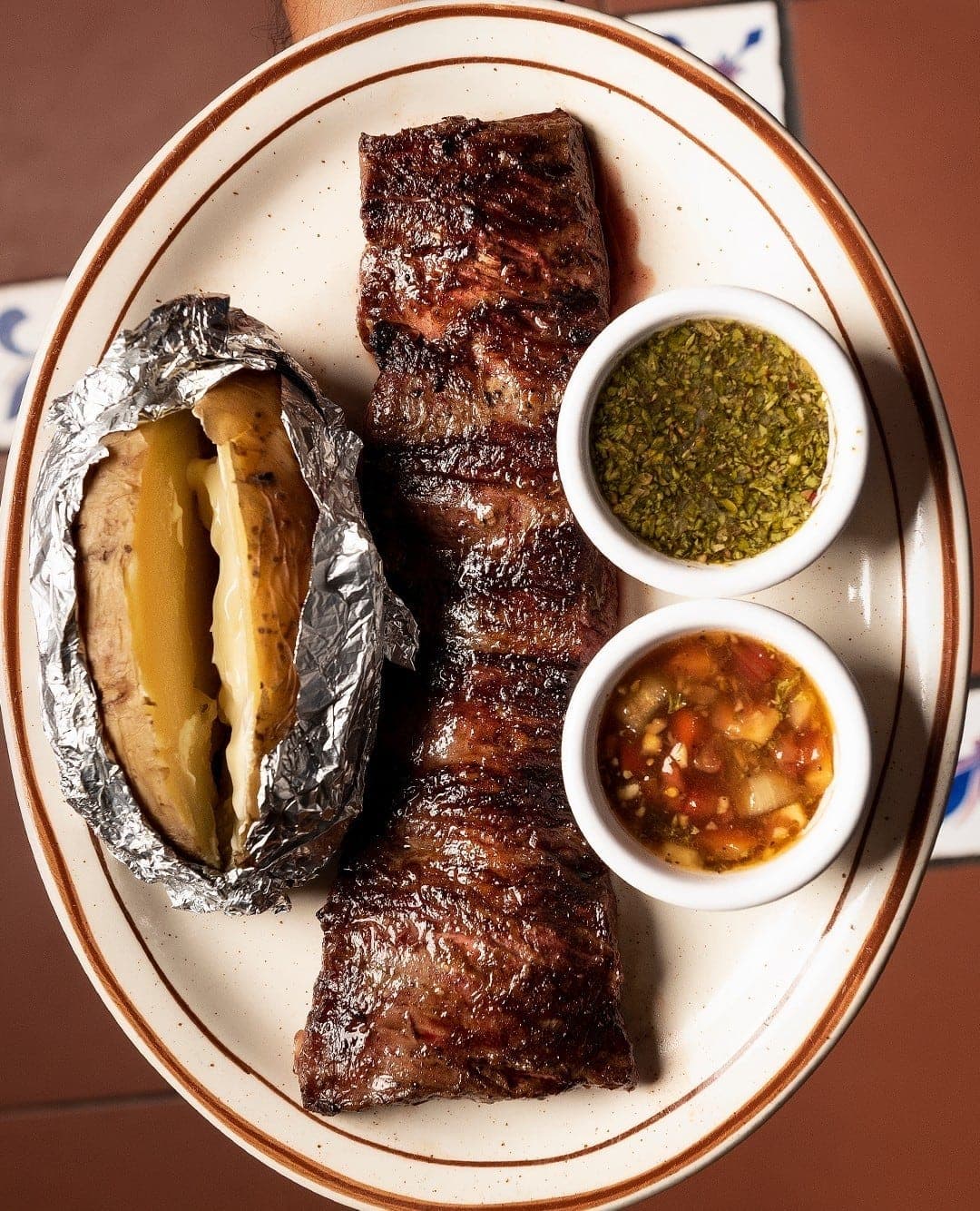 Grilled skirt steak with baked potato and chimichurri at Gauchos, Bella Vista, Panama City