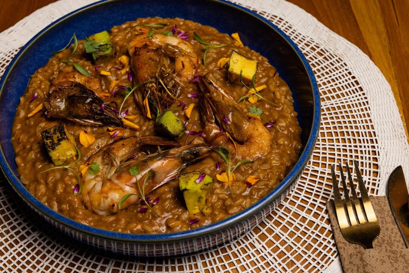 Plated shrimp risotto in a blue ceramic bowl at Köbore, Casco Viejo, Panama City