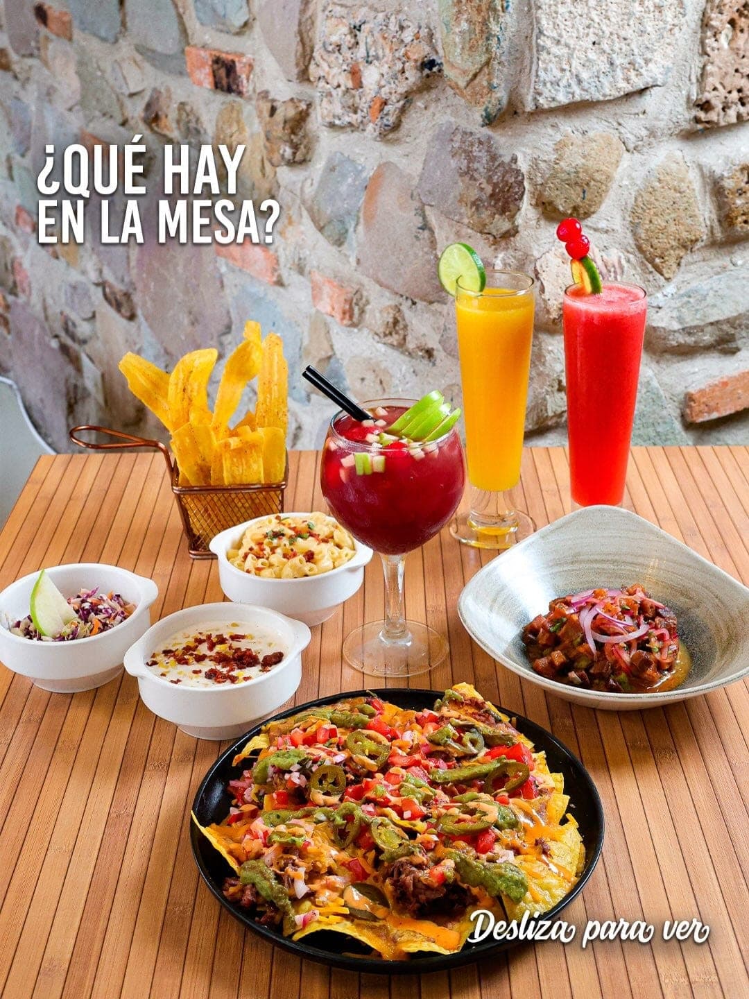 Table spread of loaded nachos, mac and cheese and plantain chips at Leños & Carbón, El Cangrejo, Panama City