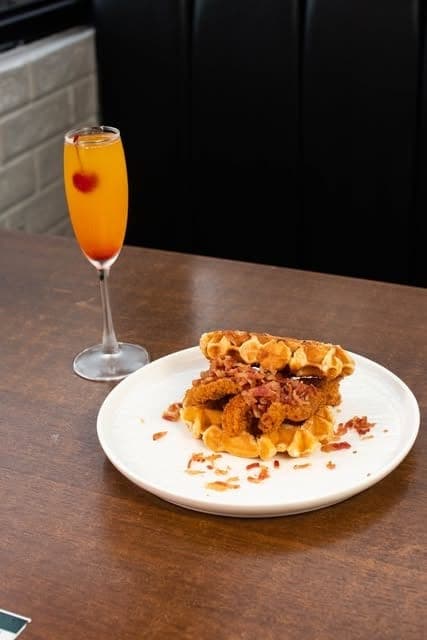 Chicken and waffles with a mimosa at Mika Bazar Cafe, Costa del Este, Panama City