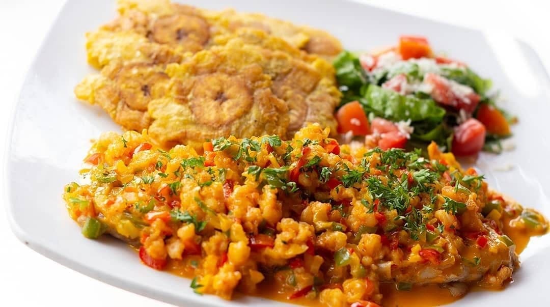 Corvina fillet in creole sauce with patacones at Pencas, Amador, Panama City