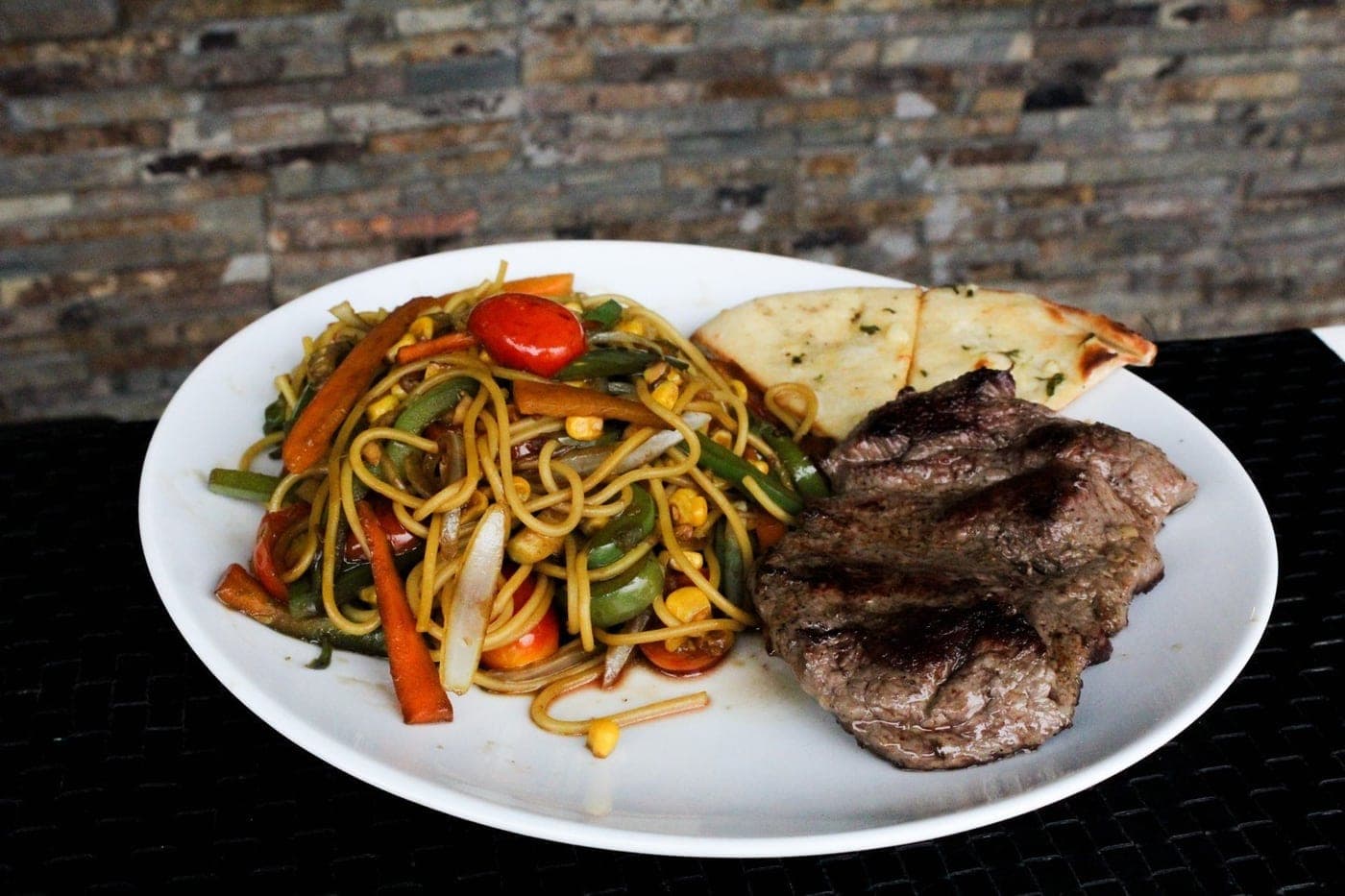 Grilled steak with vegetable noodles at Fratelli, San Francisco, Panama City
