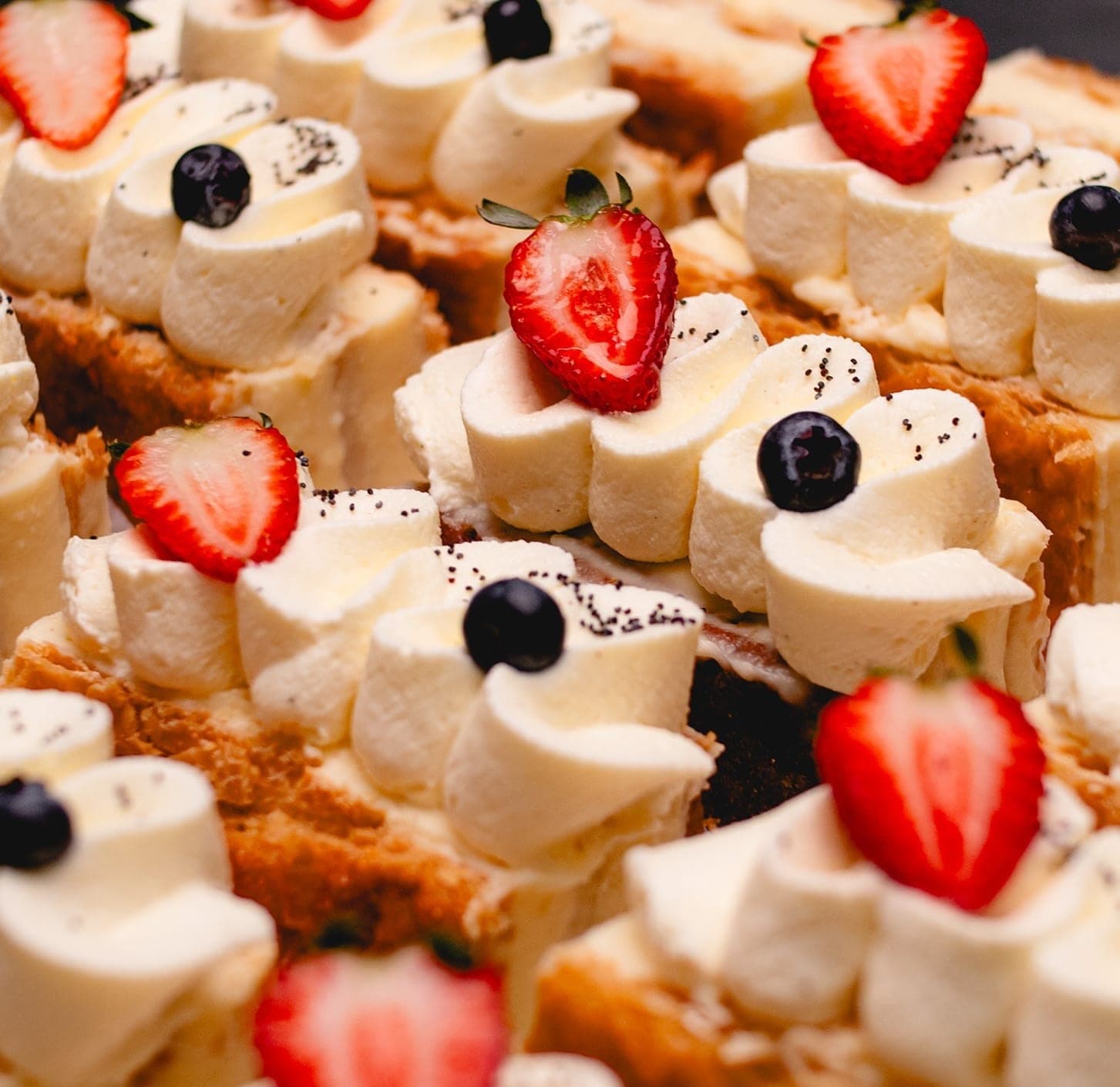 Tray of cream-topped pastries with fresh berries at Saint Honoré, Casco Viejo, Panama City