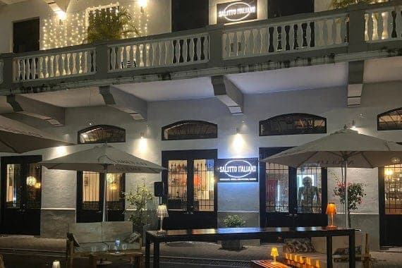 Illuminated Casco Viejo facade and terrace of Salotto Italiano at night, Panama City