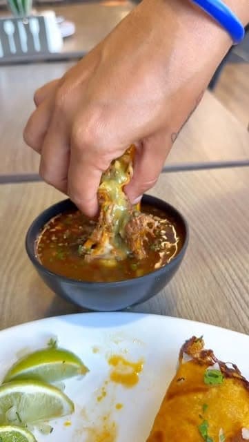 Taco dipped in consomme at Tacos el Rey, San Francisco, Panama City