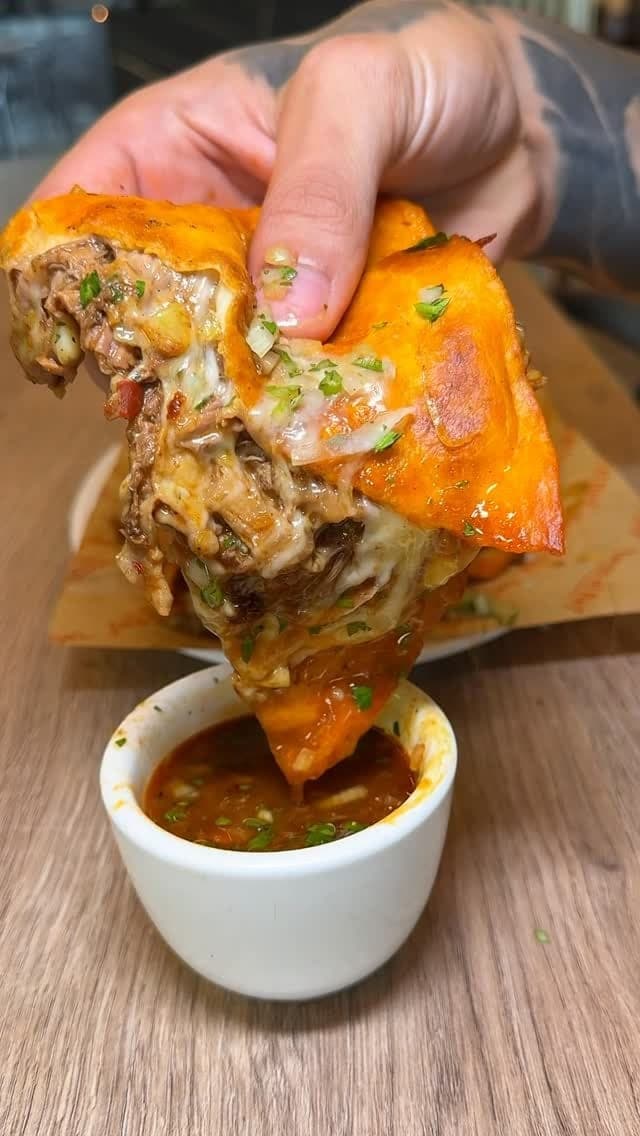 Quesabirria taco dipped in consomé at Tacos El Rey Vía Israel, Panama City