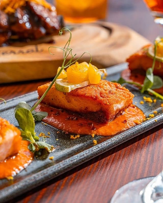 Glazed crisp-skinned fillet on smoky red pepper sauce at Terrat Rooftop, San Francisco, Panama City