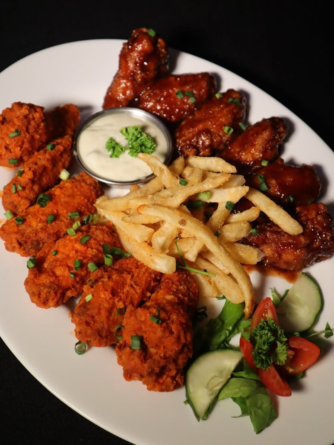 Plate of chicken wings and fries at The Bench Steakhouse, Bella Vista, Panama City